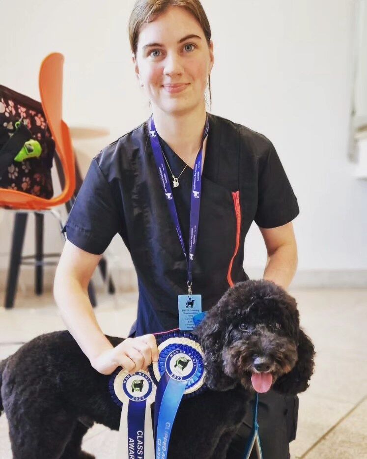 Marie Walsh, qualified dog groomer and veterinary nurse, with a client's dog